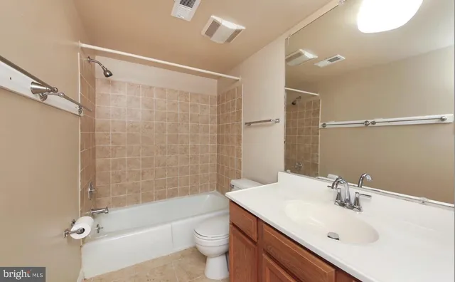 a bathroom with a sink mirror toilet and bathtub