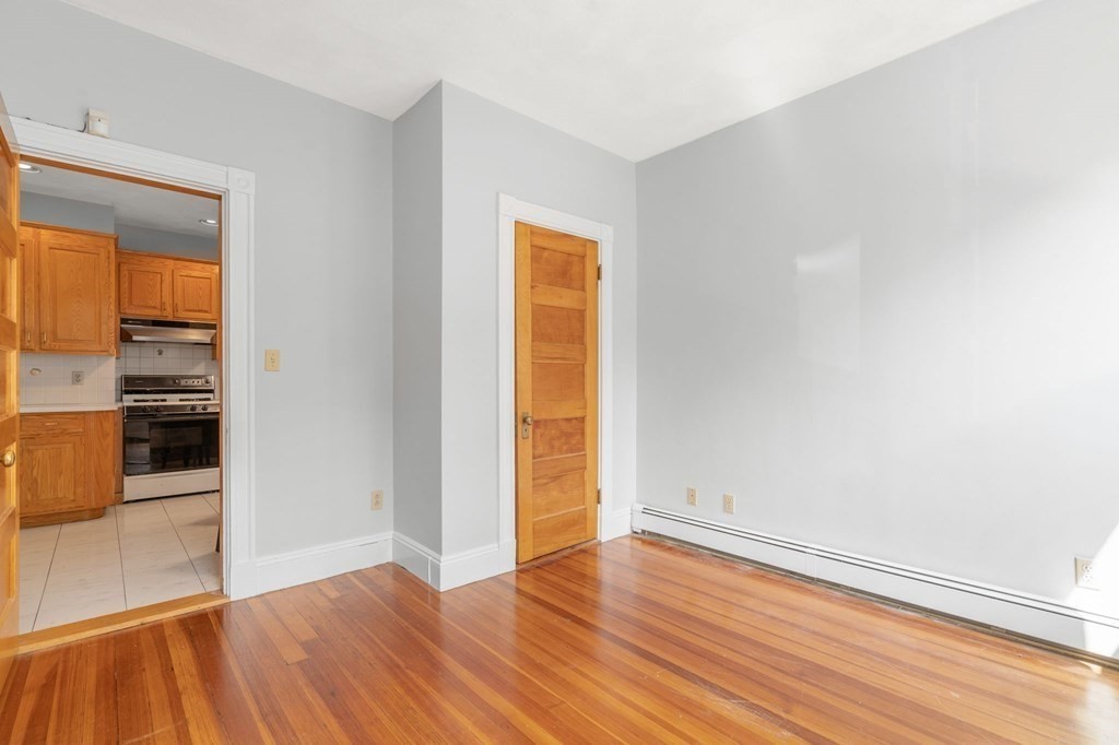 815 Centre Street, Unit 1 Boston, MA 02130 - Photo 13 of 30 an empty room with wooden floor and entrance
