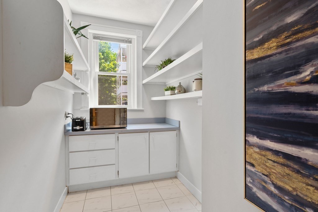 815 Centre Street, Unit 1 Boston, MA 02130 - Photo 21 of 30 a kitchen with a sink and cabinets