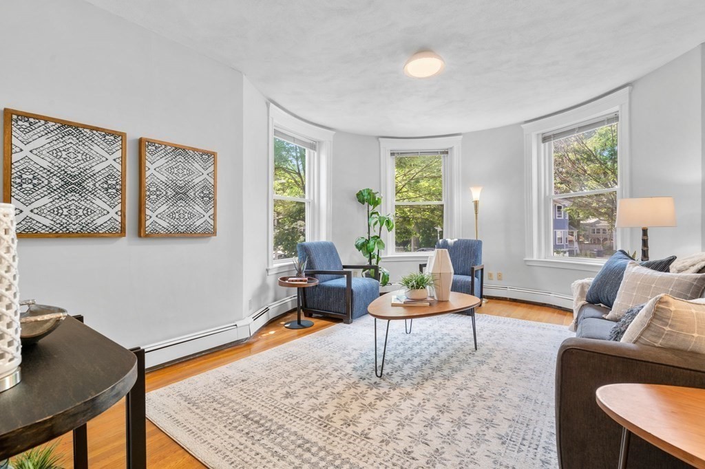 815 Centre Street, Unit 1 Boston, MA 02130 - Photo 3 of 30 a living room with furniture and a rug
