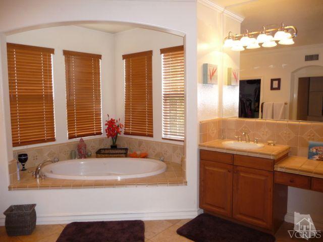 567 Oak Tree Court Simi Valley, CA 93065 - Photo 16 of 17 a bathroom with a tub sink and a mirror