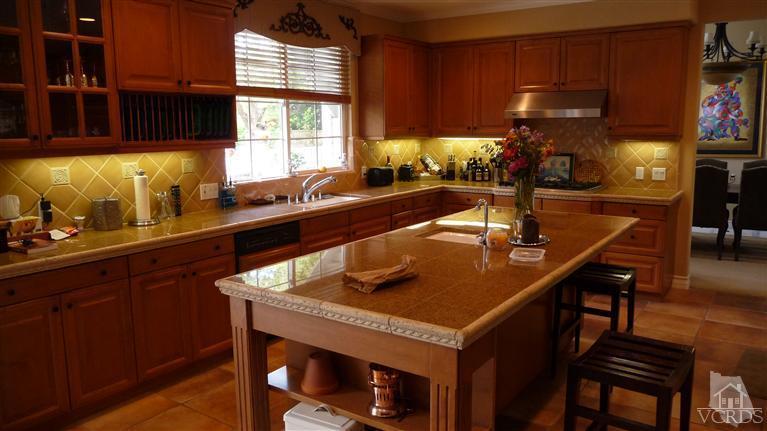 567 Oak Tree Court Simi Valley, CA 93065 - Photo 4 of 17 a kitchen with a sink a counter and chairs