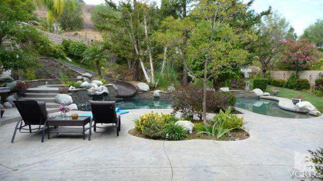 567 Oak Tree Court Simi Valley, CA 93065 - Photo 8 of 17 a view of a patio with table and chairs potted plants and large tree