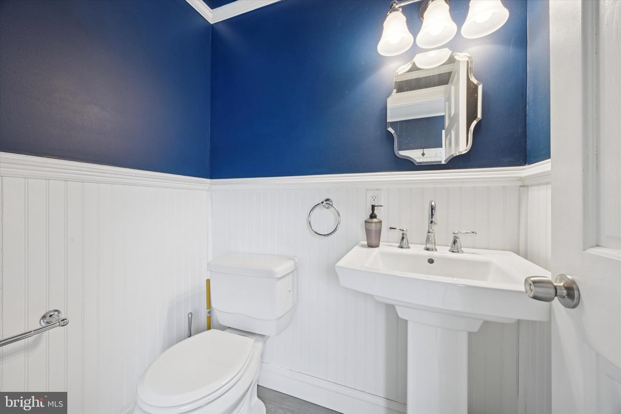 606 West Springfield Road Springfield, PA 19064 - Photo 12 of 25 a bathroom with a sink a toilet and mirror