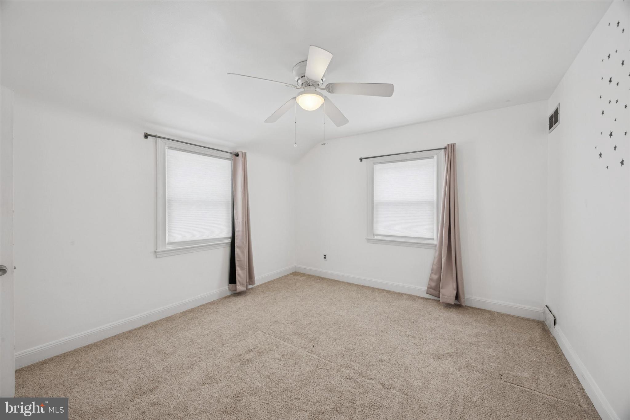 606 West Springfield Road Springfield, PA 19064 - Photo 18 of 25 an empty room with a ceiling fan and a window