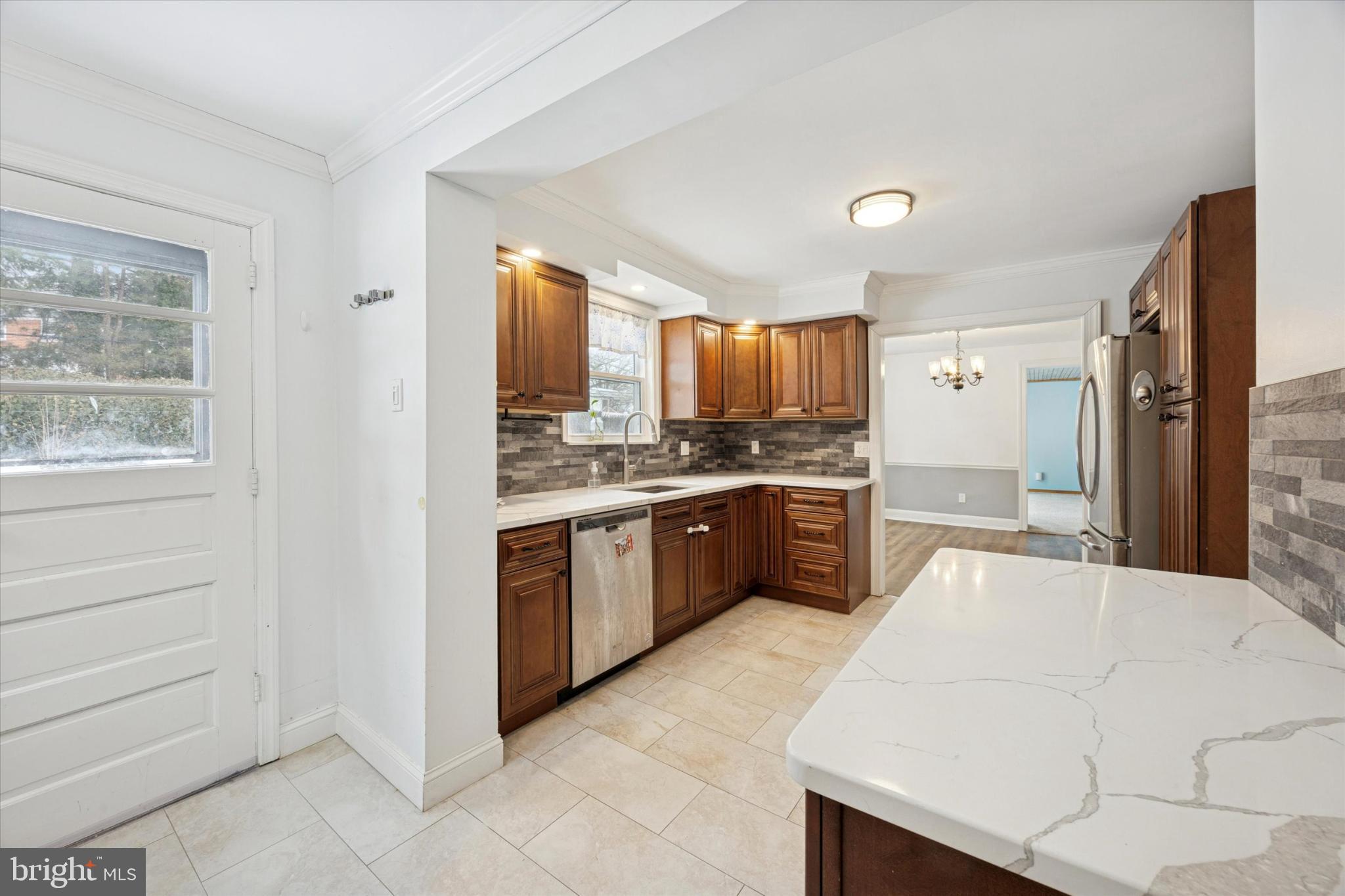 606 West Springfield Road Springfield, PA 19064 - Photo 8 of 25 a kitchen with a refrigerator sink and cabinets