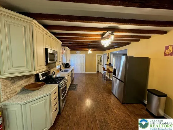 a kitchen with sink cabinets and wooden floor