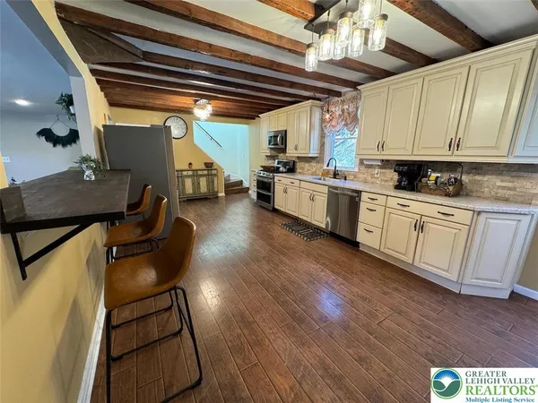 a kitchen with sink cabinets and wooden floor