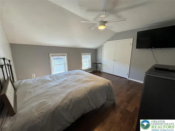 a bedroom with a bed and a flat screen tv