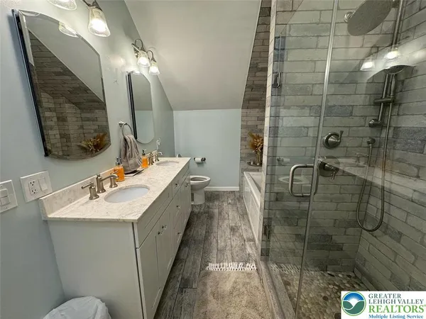 a bathroom with a sink shower and a mirror
