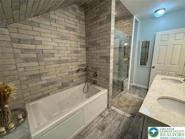 a bathroom with a bathtub and a sink