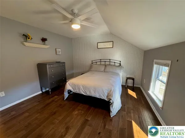 a bed room with a bed window and a desk