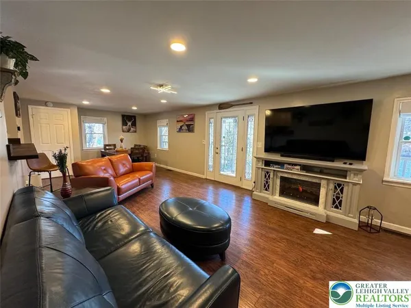 a living room with furniture and a flat screen tv