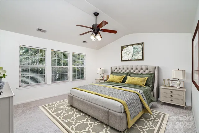 a bedroom with a large bed and a window