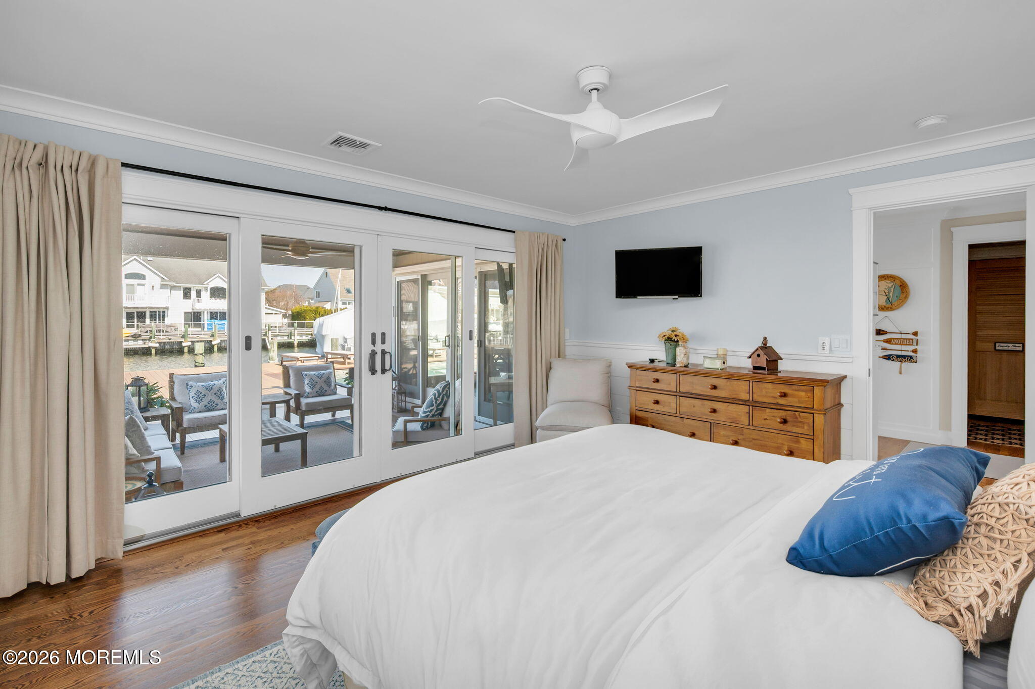 149 Squan Beach Drive Mantoloking, NJ 08738 - Photo 23 of 47 a bedroom with a large bed and a flat tv screen
