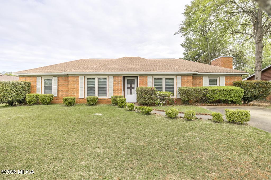 a front view of a house with a yard and porch