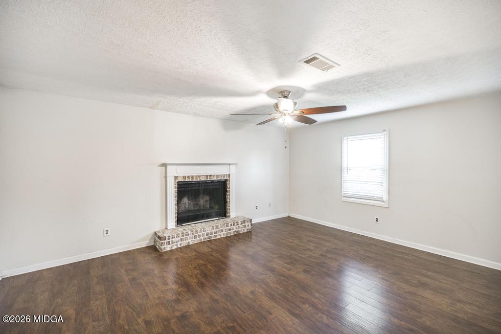 112 Prairie Boulevard Centerville, GA 31028 - Photo 17 of 32 an empty room with windows and fireplace