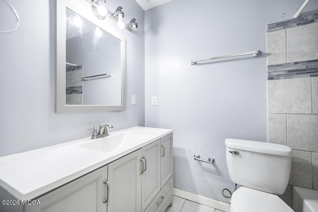 112 Prairie Boulevard Centerville, GA 31028 - Photo 25 of 32 a bathroom with a toilet sink and mirror