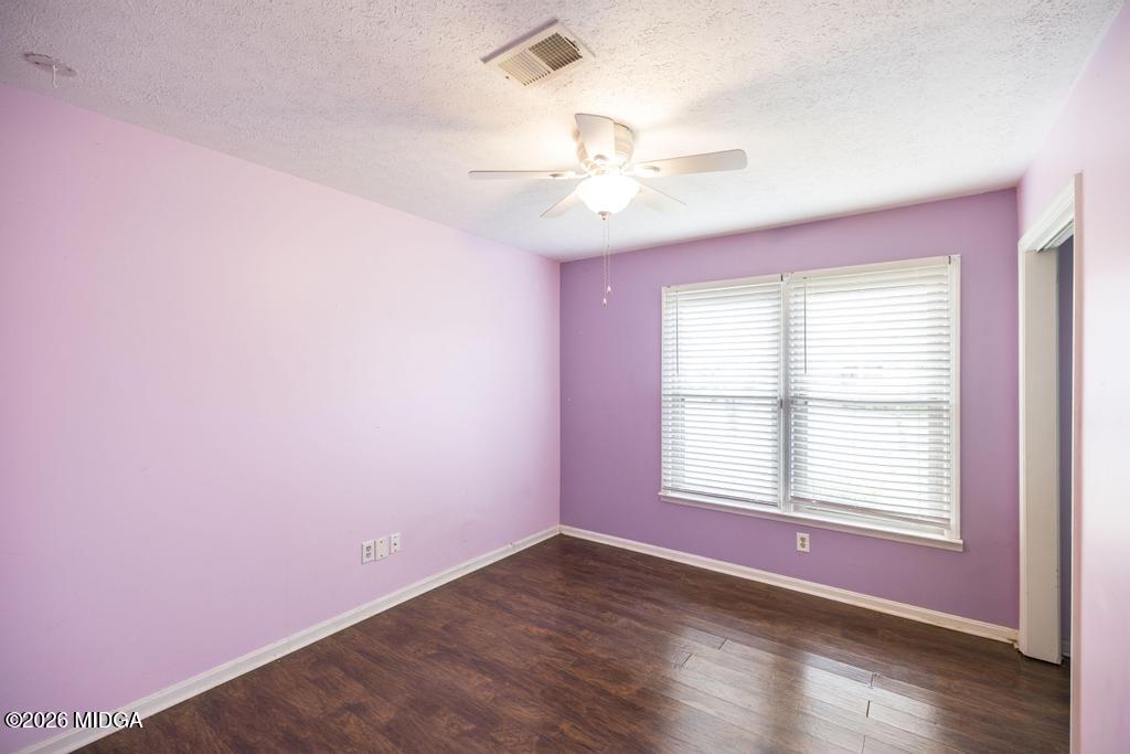 112 Prairie Boulevard Centerville, GA 31028 - Photo 26 of 32 a view of an empty room with wooden floor and a window