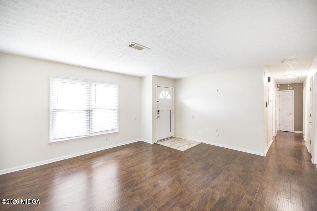 112 Prairie Boulevard Centerville, GA 31028 - Photo 9 of 32 an empty room with wooden floor and windows