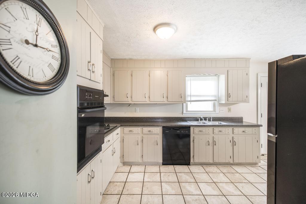 112 Prairie Boulevard Centerville, GA 31028 - Photo 10 of 32 a kitchen with granite countertop a sink a stove a refrigerator a washer and dryer