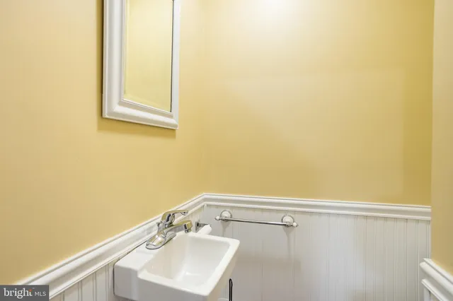 a bathroom with a sink a vanity and a window