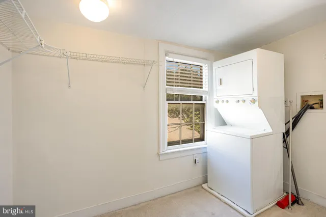 a view of storage and utility room with a window