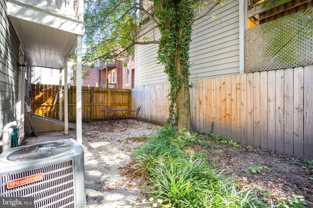 a view of a chair and table in backyard