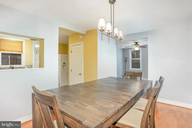 a view of a dining room with furniture wooden floor and chandelier