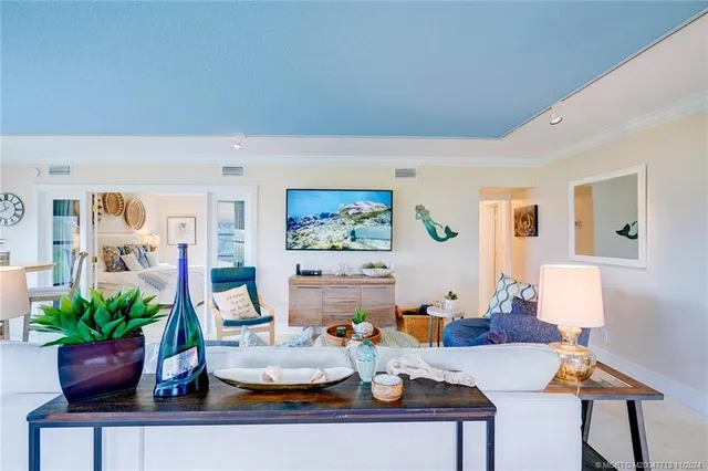 a dining room with furniture and a floor to ceiling window