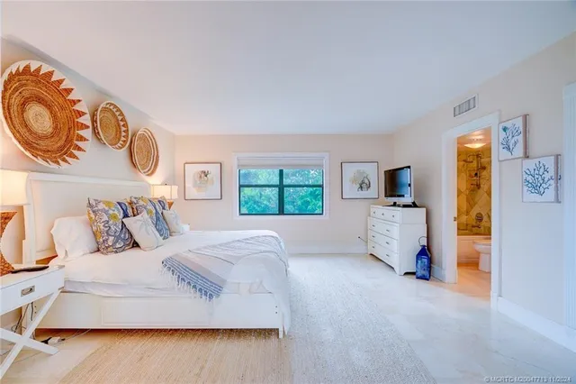 a bedroom with a large bed and a window