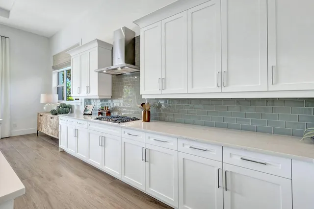 a kitchen with granite countertop white cabinets and white appliances