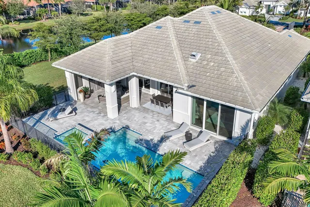 an aerial view of a house with yard and patio