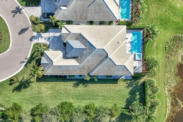 an aerial view of a house with swimming pool garden and patio