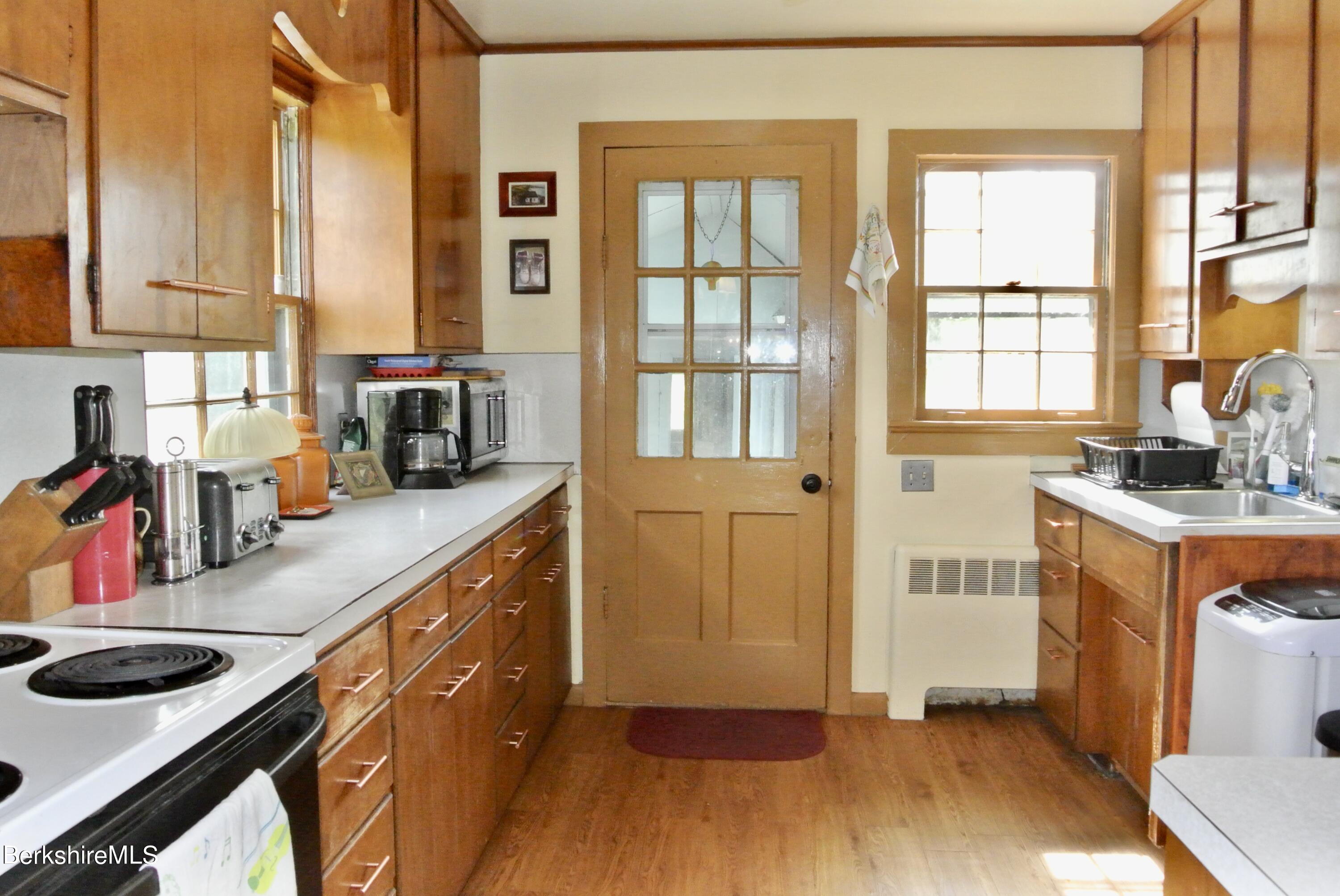 105 Yokun Road Richmond, MA 01201 - Photo 12 of 37 a kitchen with stainless steel appliances a sink and cabinets