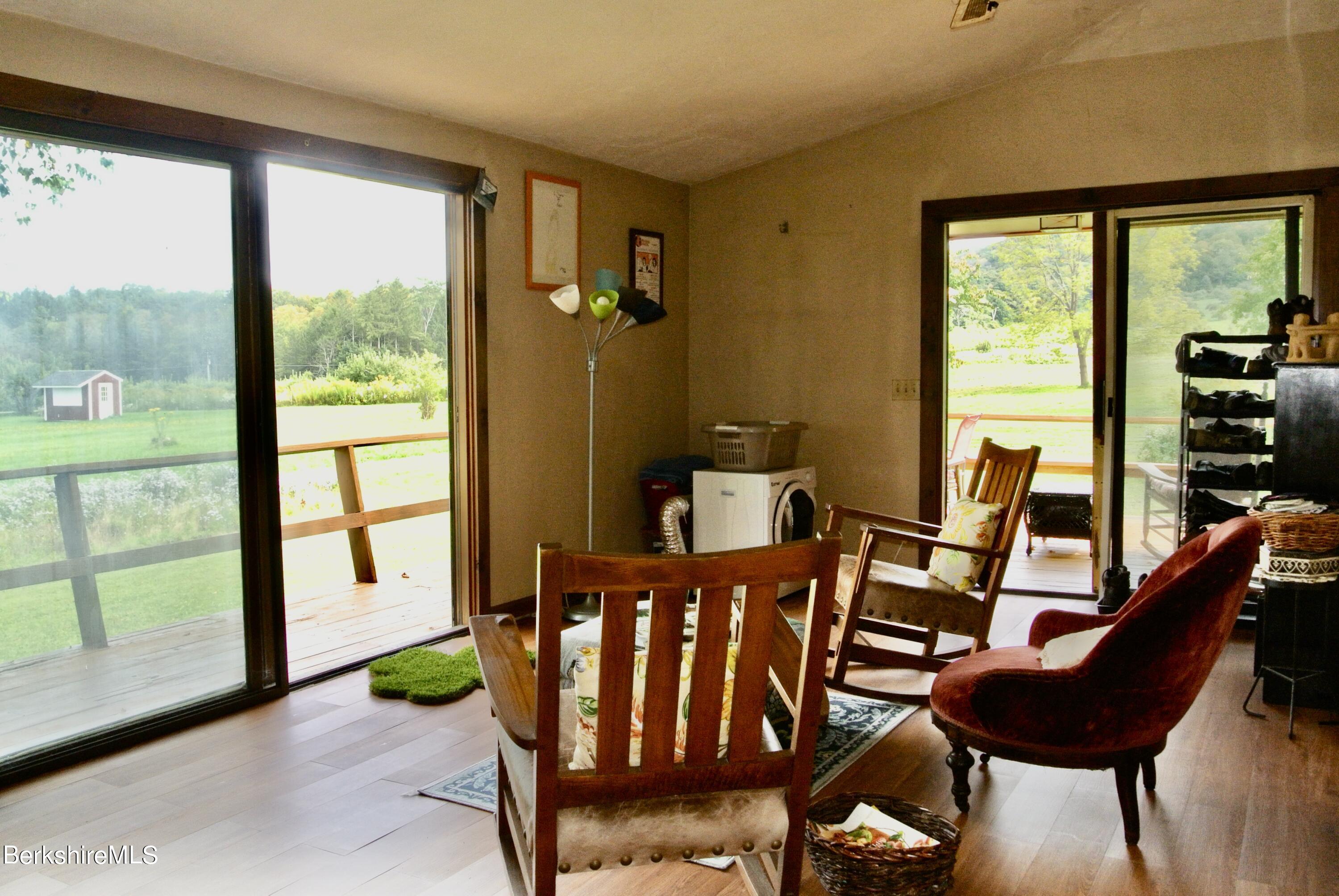 105 Yokun Road Richmond, MA 01201 - Photo 16 of 37 a view of a porch with furniture and a yard