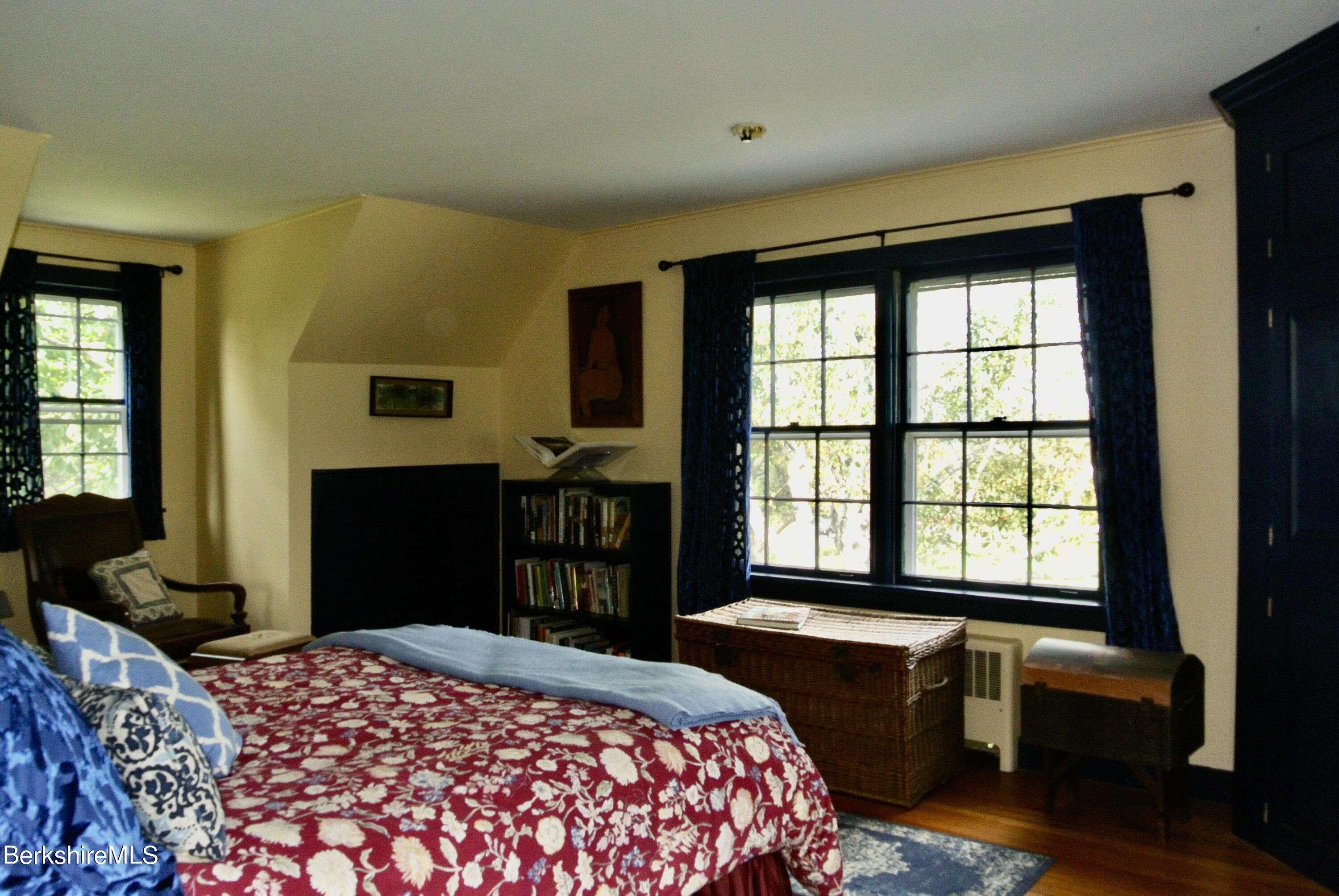105 Yokun Road Richmond, MA 01201 - Photo 22 of 37 a bedroom with a bed and wooden floor