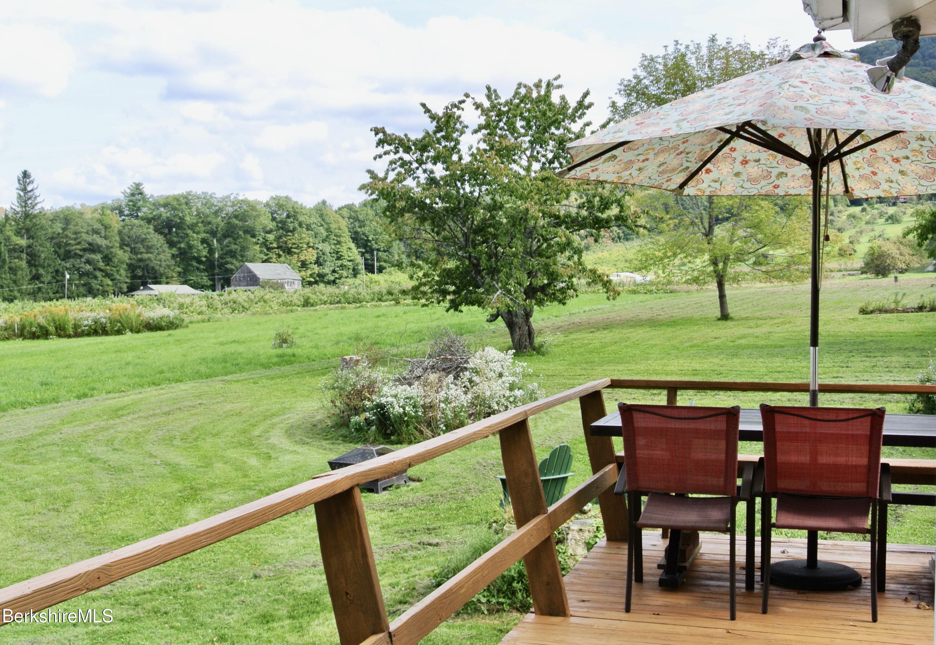 105 Yokun Road Richmond, MA 01201 - Photo 27 of 37 a view of a chairs and table in the deck