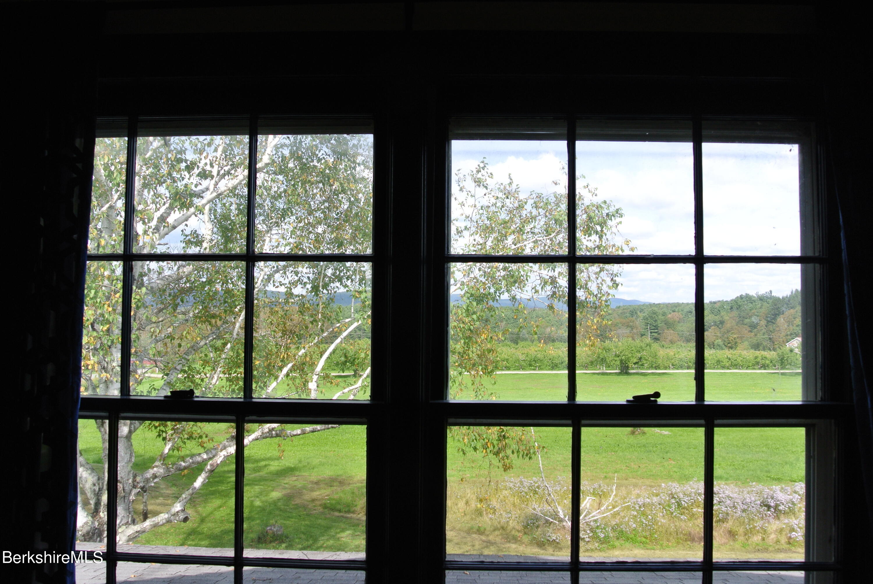 105 Yokun Road Richmond, MA 01201 - Photo 28 of 37 a view of large green with large glass windows