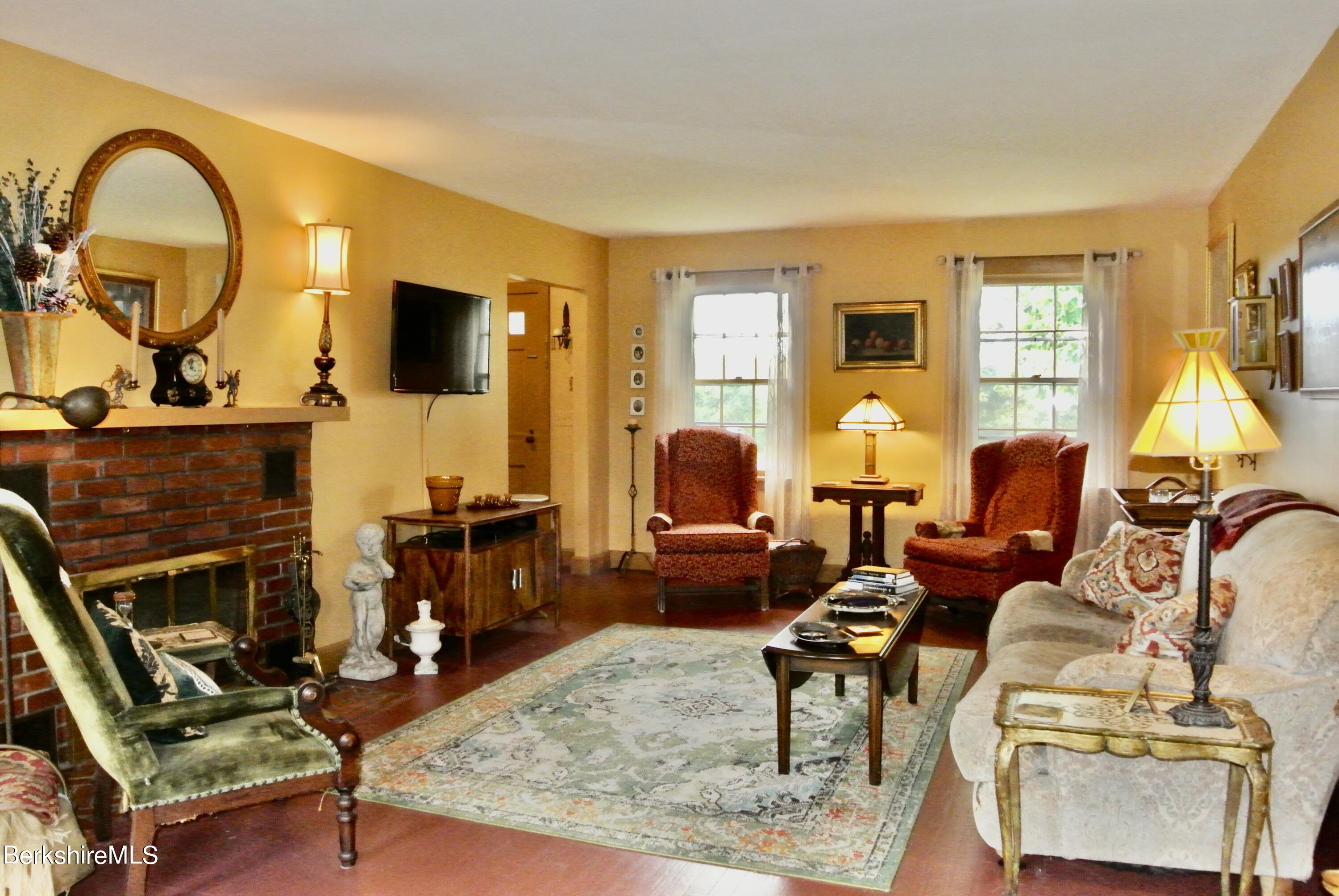 105 Yokun Road Richmond, MA 01201 - Photo 7 of 37 a living room with furniture a flat screen tv and a fireplace