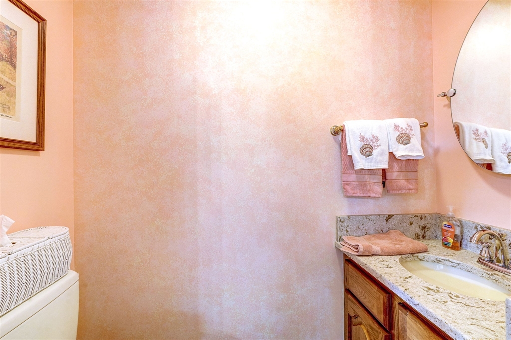 138 Quincy Shore Drive, Unit 170 Quincy, MA 02171 - Photo 17 of 41 a bathroom with a granite countertop sink and a mirror