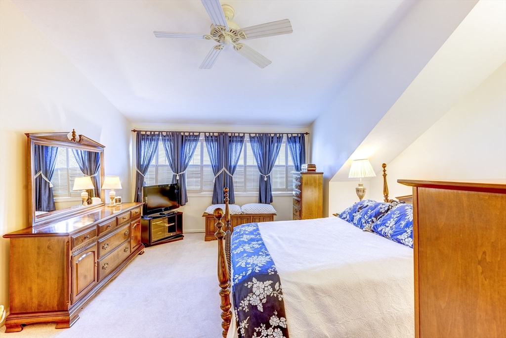 138 Quincy Shore Drive, Unit 170 Quincy, MA 02171 - Photo 31 of 41 a bed room with a bed and a tv