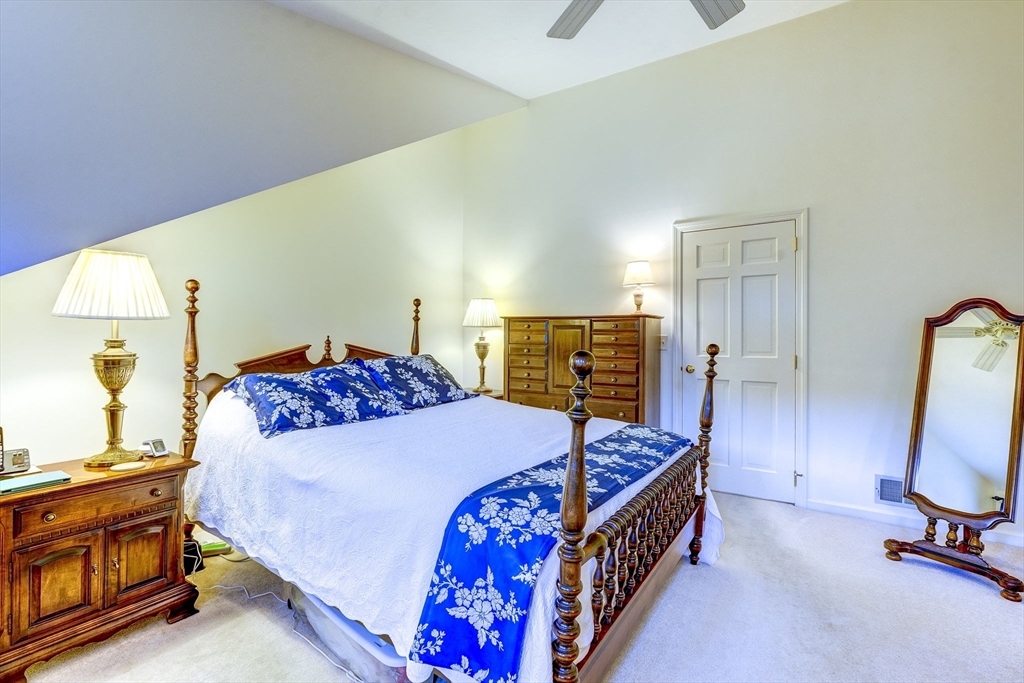 138 Quincy Shore Drive, Unit 170 Quincy, MA 02171 - Photo 33 of 41 a bedroom with a bed a dresser and flat screen tv