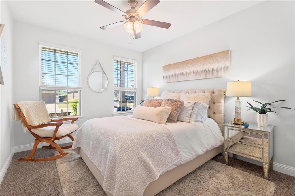 2816 Permian Road Aubrey, TX 76227 - Photo 16 of 36 Bedroom featuring ceiling fan and carpet flooring