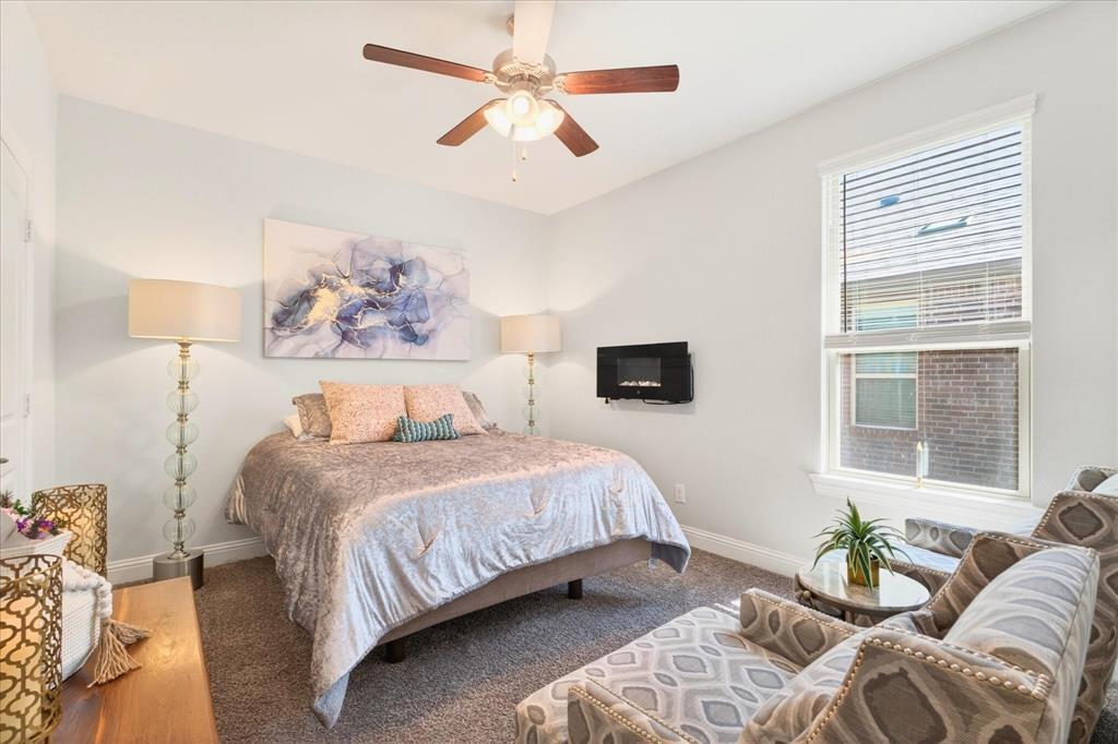 2816 Permian Road Aubrey, TX 76227 - Photo 17 of 36 Carpeted bedroom with baseboards and ceiling fan