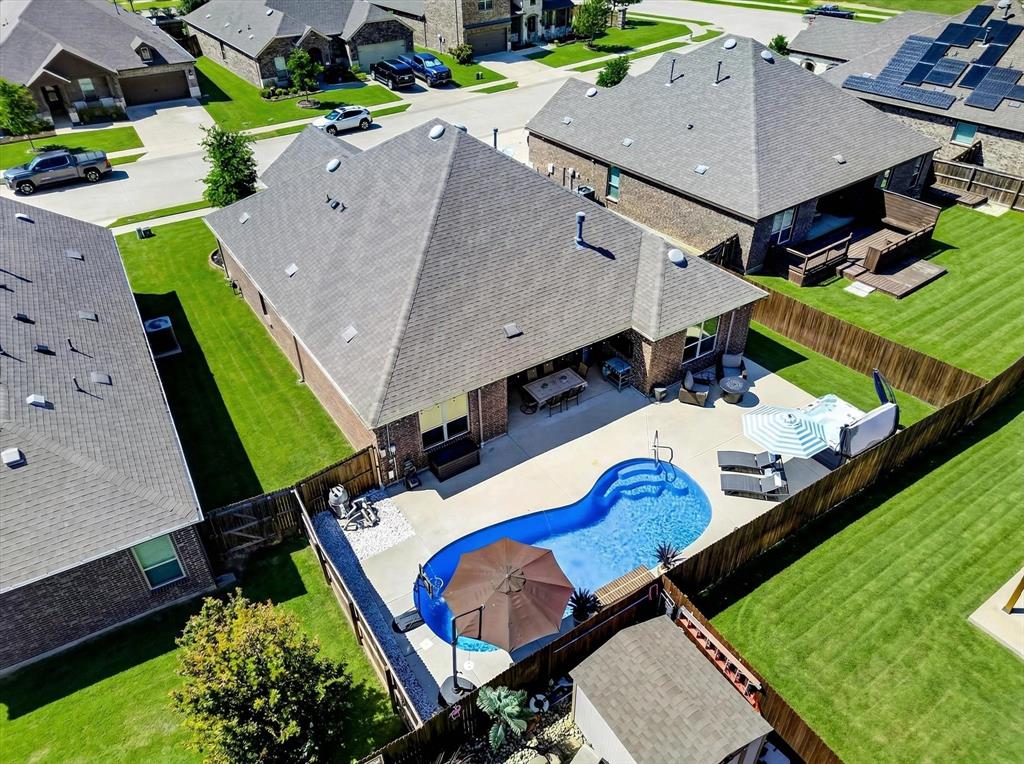 2816 Permian Road Aubrey, TX 76227 - Photo 20 of 36 Aerial perspective of suburban area featuring a pool