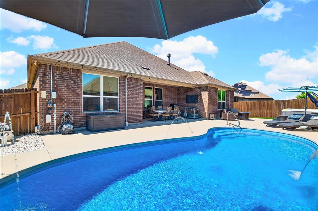 2816 Permian Road Aubrey, TX 76227 - Photo 2 of 36 View of swimming pool featuring a fenced backyard and patio surround