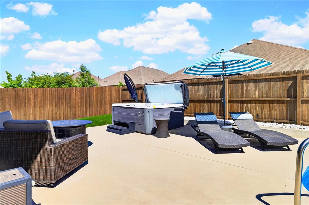 2816 Permian Road Aubrey, TX 76227 - Photo 21 of 36 Fenced backyard featuring a hot tub and a patio area