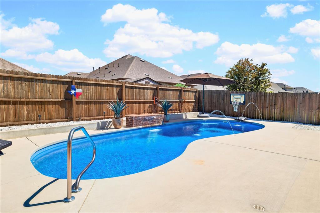 2816 Permian Road Aubrey, TX 76227 - Photo 22 of 36 View of pool with a fenced backyard and patio surround