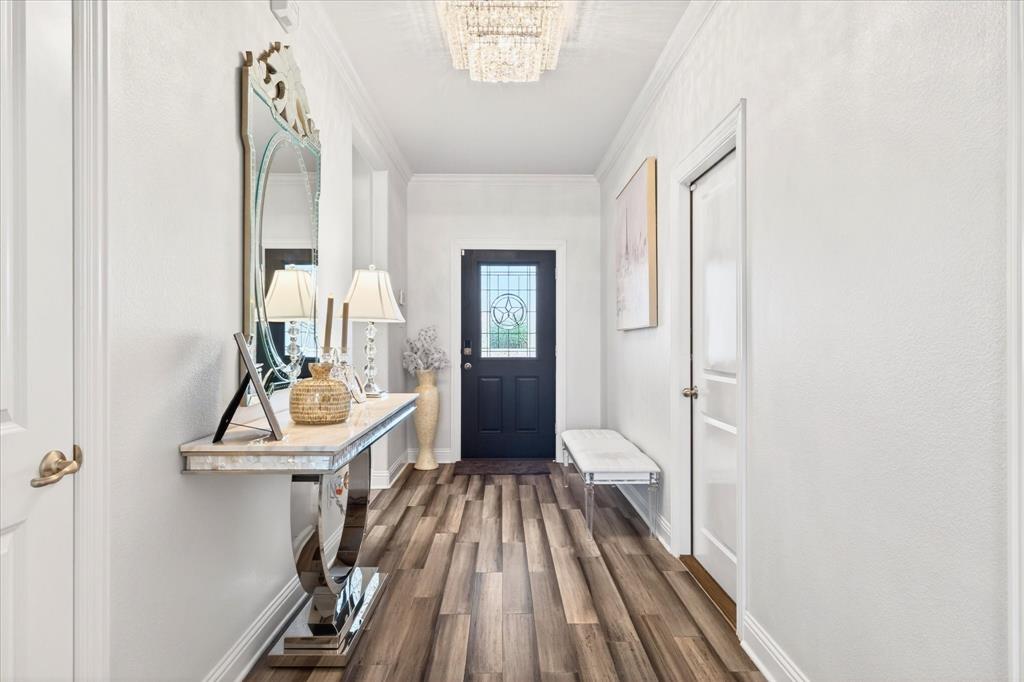 2816 Permian Road Aubrey, TX 76227 - Photo 26 of 36 Entryway featuring wood finished floors and ornamental molding